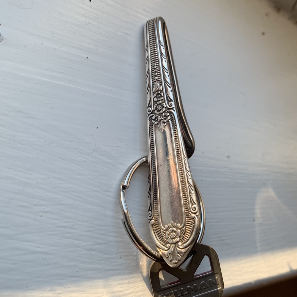 Silver purse hook helps find keys quickly.